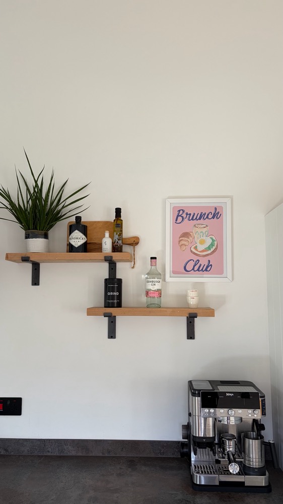 Kitchen shelves with a Brunch Club print and coffee machine